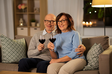 Image showing happy senior couple with glasses of red wine