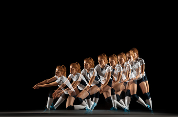 Image showing Young female volleyball player isolated on black studio background