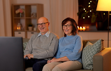 Image showing happy senior couple watching tv at home