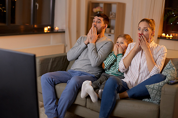 Image showing scared family watching tv at home at night