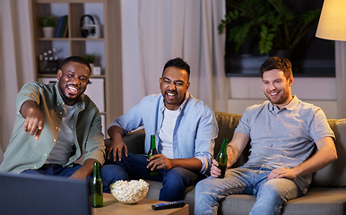 Image showing happy male friends with beer watching tv at home