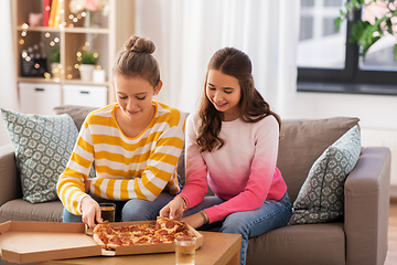 Image showing happy teenage girls eating takeaway pizza at home