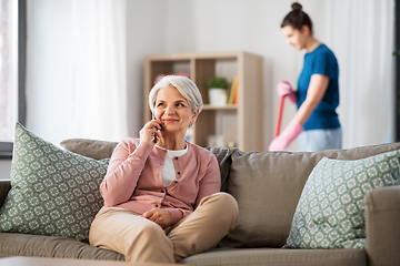 Image showing happy senior woman calling on smartphone at home