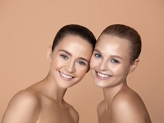 Image showing Portrait of beautiful young women isolated on brown studio background