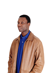 Image showing Serious African man standing in leather jacket