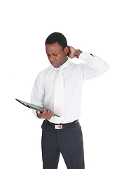 Image showing African business man paper, scratching his head
