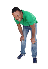 Image showing Happy African man in jeans bending down