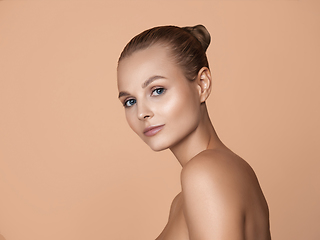 Image showing Portrait of beautiful young woman isolated on brown studio background