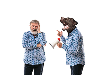 Image showing Senior man arguing with himself as a dog on white studio background.