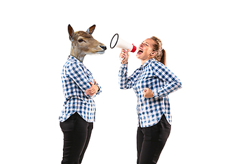 Image showing Young handsome woman arguing with herself as a deer on white studio background.