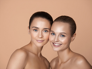 Image showing Portrait of beautiful young women isolated on brown studio background