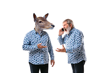 Image showing Senior man arguing with himself as a deer on white studio background.