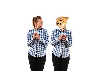 Image showing Young handsome woman arguing with herself as a leopard on white studio background.