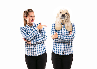 Image showing Young handsome woman arguing with herself as a dog on white studio background.