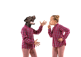 Image showing Young handsome girl arguing with herself as a dog on white studio background.