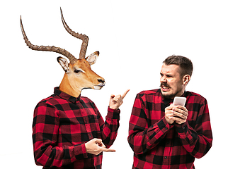 Image showing Man arguing with himself as a deer on white studio background.