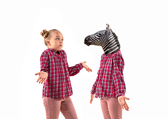 Image showing Young handsome girl arguing with herself as a zebra on white studio background.