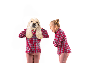 Image showing Young handsome girl arguing with herself as a dog on white studio background.