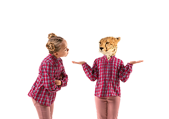 Image showing Young handsome girl arguing with herself as a leopard on white studio background.