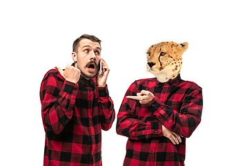 Image showing Man arguing with himself as a leopard on white studio background.