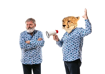 Image showing Senior man arguing with himself as a leopard on white studio background.