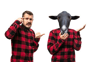 Image showing Man arguing with himself as a donkey on white studio background.