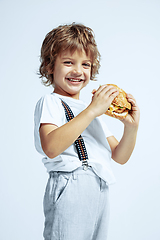 Image showing Pretty young boy in casual clothes on white studio background