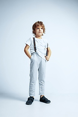 Image showing Pretty young boy in casual clothes on white studio background