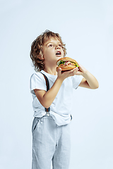 Image showing Pretty young boy in casual clothes on white studio background