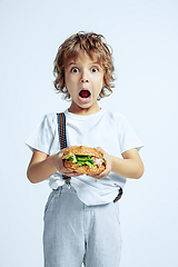 Image showing Pretty young boy in casual clothes on white studio background