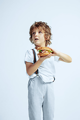 Image showing Pretty young boy in casual clothes on white studio background