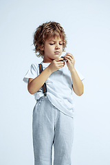 Image showing Pretty young boy in casual clothes on white studio background