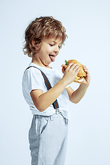 Image showing Pretty young boy in casual clothes on white studio background