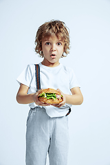 Image showing Pretty young boy in casual clothes on white studio background