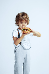 Image showing Pretty young boy in casual clothes on white studio background