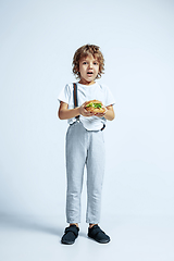 Image showing Pretty young boy in casual clothes on white studio background