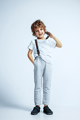 Image showing Pretty young boy in casual clothes on white studio background