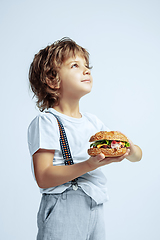 Image showing Pretty young boy in casual clothes on white studio background