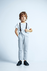 Image showing Pretty young boy in casual clothes on white studio background