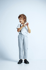 Image showing Pretty young boy in casual clothes on white studio background