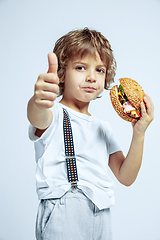 Image showing Pretty young boy in casual clothes on white studio background