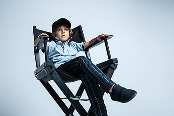 Image showing Pretty young boy in casual clothes on white studio background