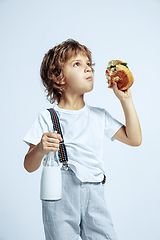 Image showing Pretty young boy in casual clothes on white studio background