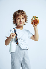 Image showing Pretty young boy in casual clothes on white studio background