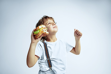 Image showing Pretty young boy in casual clothes on white studio background