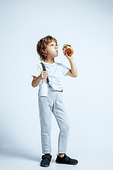 Image showing Pretty young boy in casual clothes on white studio background