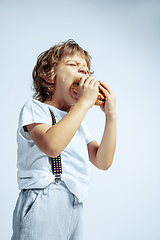 Image showing Pretty young boy in casual clothes on white studio background