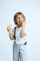 Image showing Pretty young boy in casual clothes on white studio background