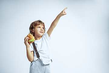 Image showing Pretty young boy in casual clothes on white studio background