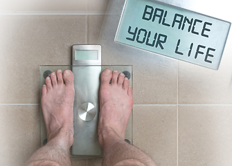 Image showing Man\'s feet on weight scale - Balance your life